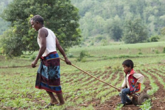 Farmer-with-his-child-in-field-1