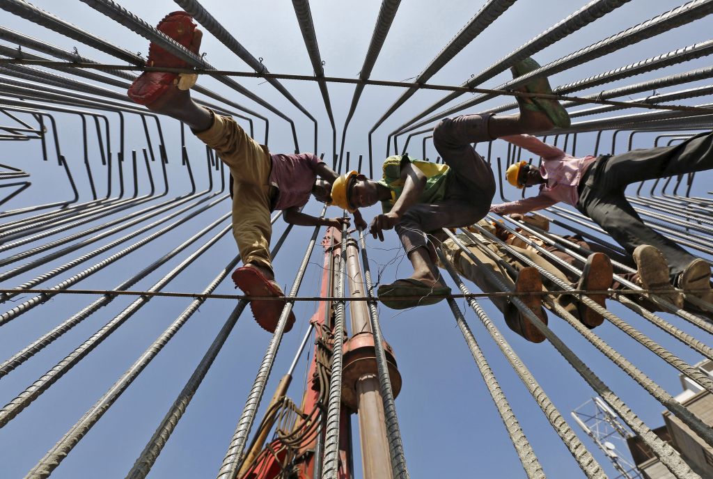 Labourers-work-at-the-construction-site-of-an-overhead-road-bridge-in-Ahmedabad-India-October-30-2015.-REUTERS